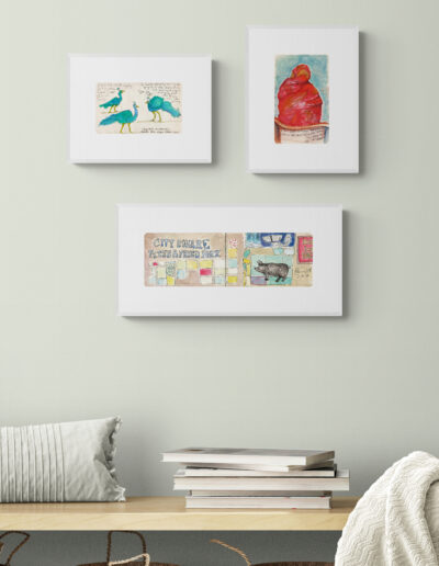 art prints in white frames in airy hallway light green wall archival limited edition singed ink and watercolour wall art