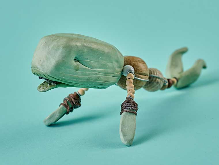 Whale character made out of green clay, wire and beads